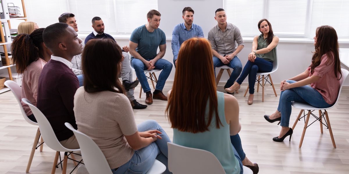 Group of people talking to therapist