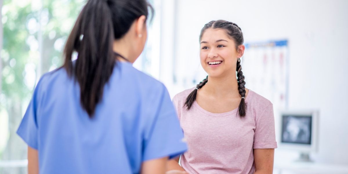 Teenager talking to clinician