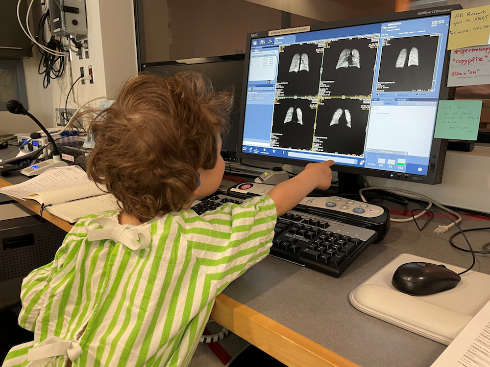 Child sitting at MRI control desk