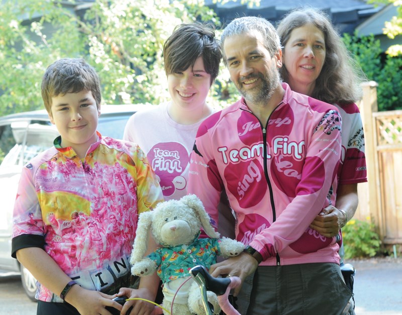 Patrick, Samantha, Baird and Sarah wearing team jerseys at a bike ride fundraiser.