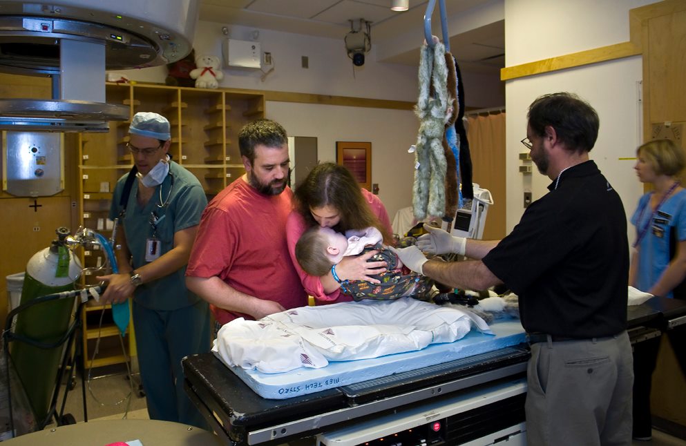 Patrick Sullivan and Samantha Mason hold their son Finn as he is prepared for cancer treatment.