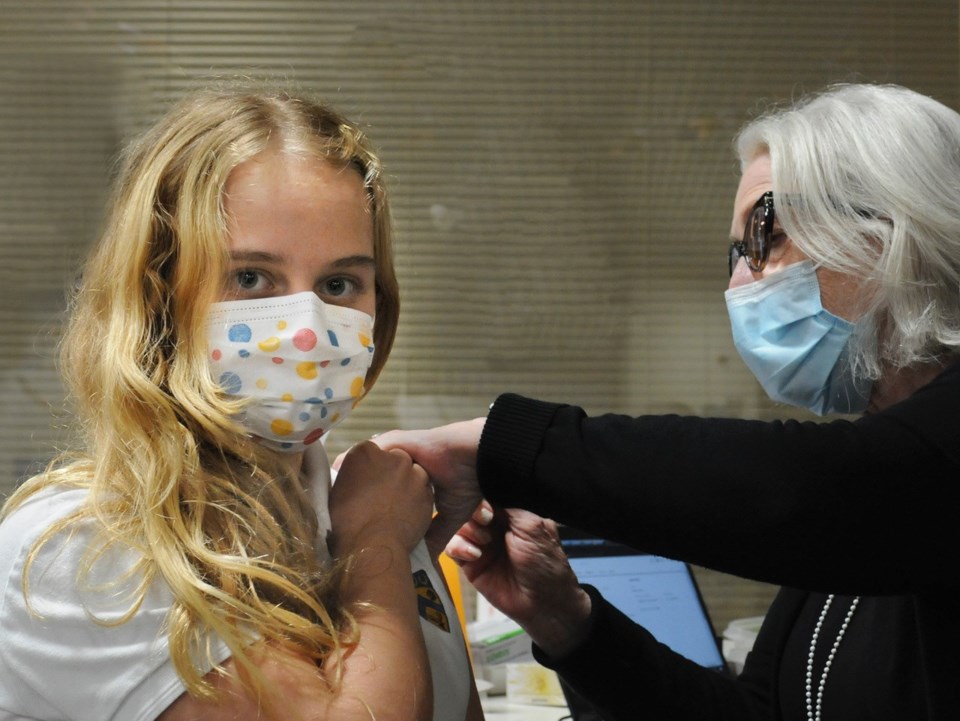 A child receives a COVID-19 vaccine