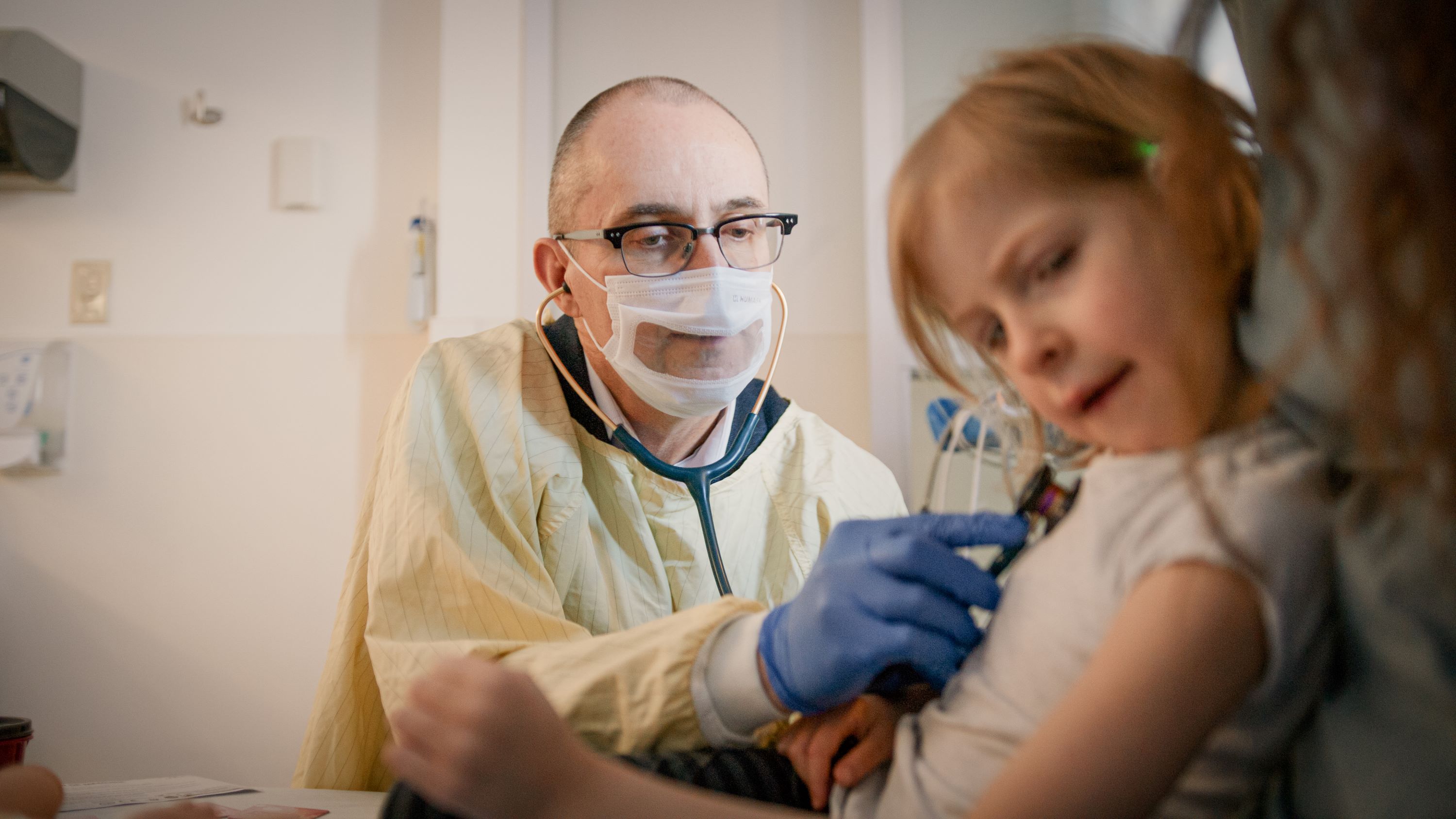 Stuart Turvey listening to a patient's heart