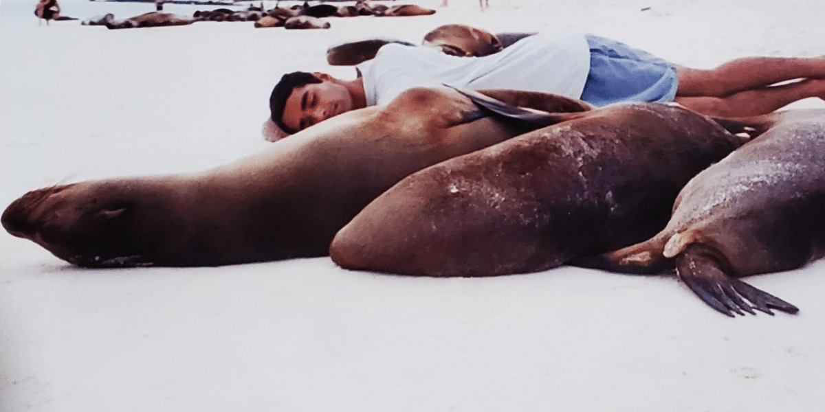Dr. Manish Sadarangani sleeps with sea lions on Galapagos Islands.