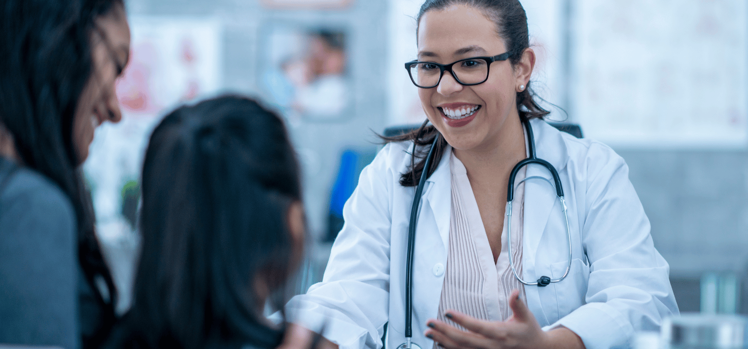 A doctor speaking to a mother and child