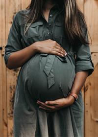 Pregnant woman holds her belly