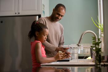 Father and daughter washing hands