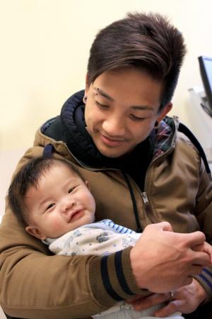 father holding baby