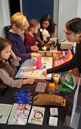 children engage in science activities at an information booth