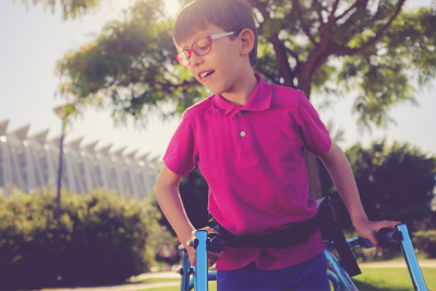 Smiling child using walker