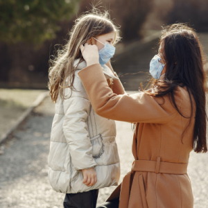 Mom adjusting child's mask