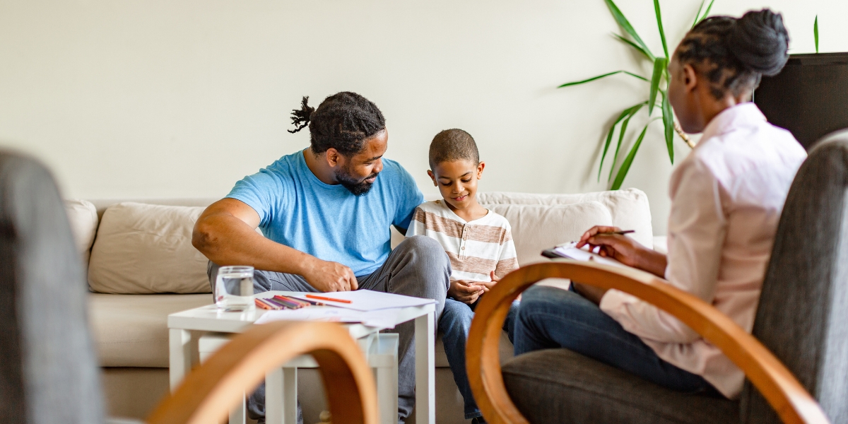 Caregiver with child and therapist