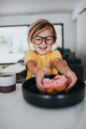 kid eating donut