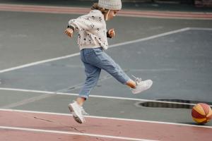 a little girl kicking a soccer ball