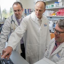 LSARP Collaborators; Drs. Brett Finlay, Mike Kobor and Stuart Turvey analyzing data, 2018; Photo courtesy of Genome Canada; Credit: Canadian Press