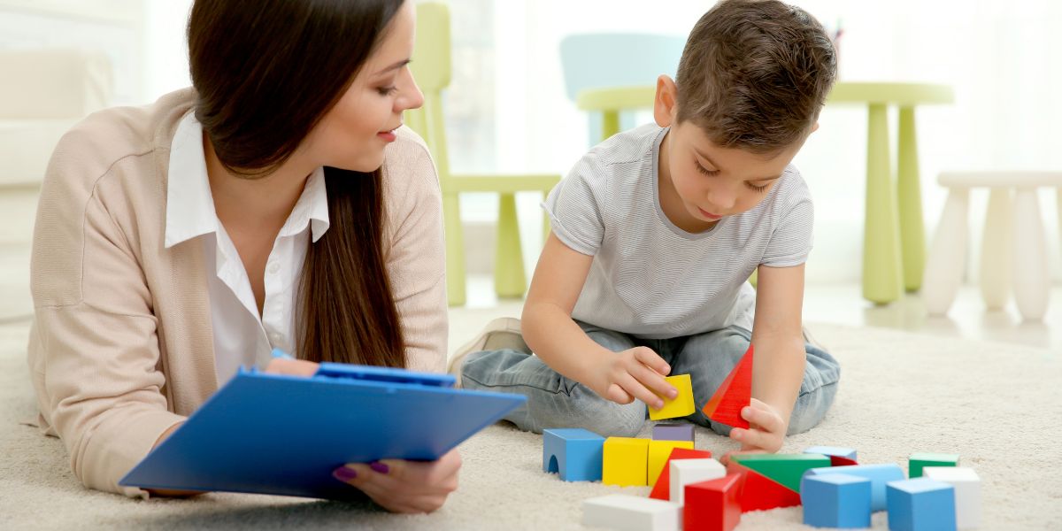 Eight-year-old child playing with psychologist