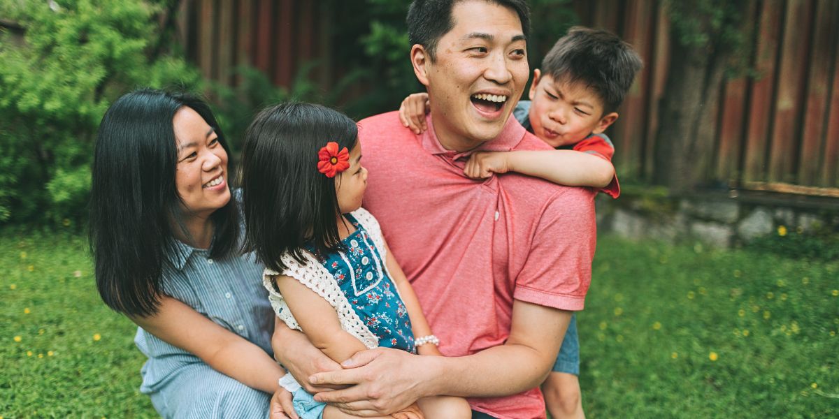 Parents playing with kids outdoors.