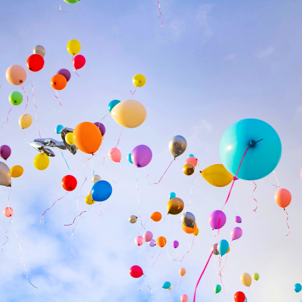 Balloons floating up into the sky.