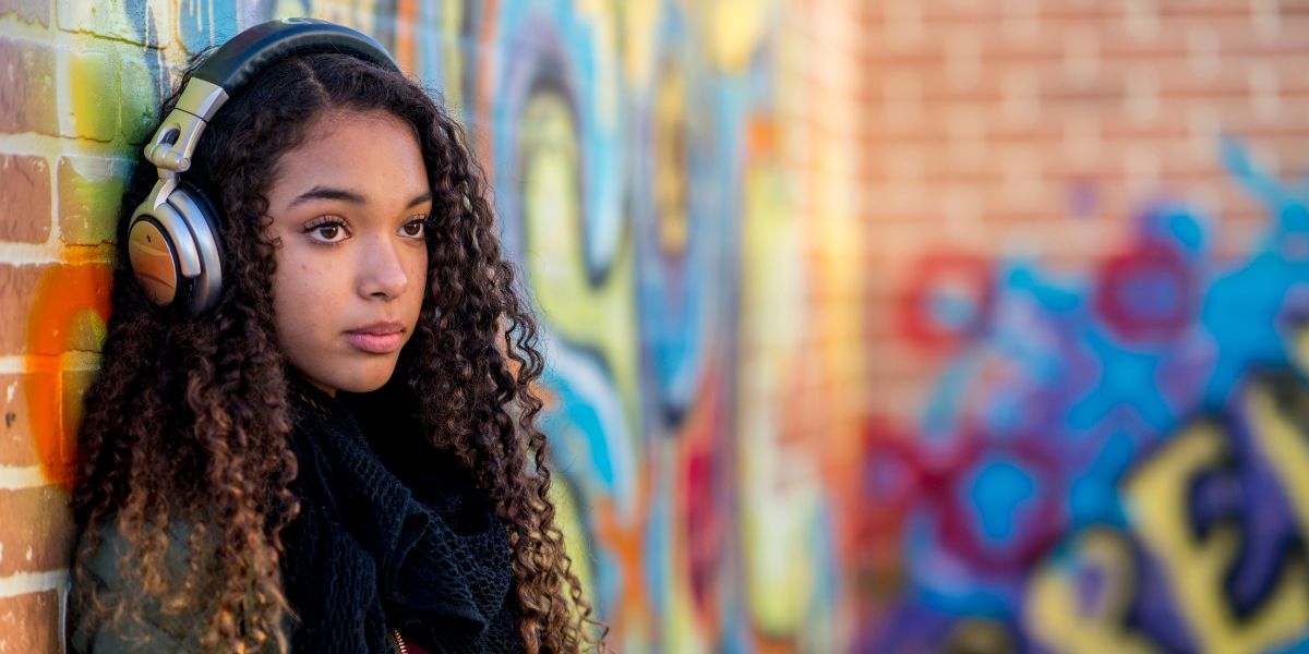 Female teenager near a wall with graffiti