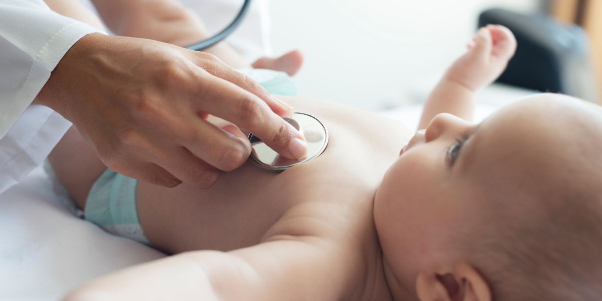 Baby being examined by clinician