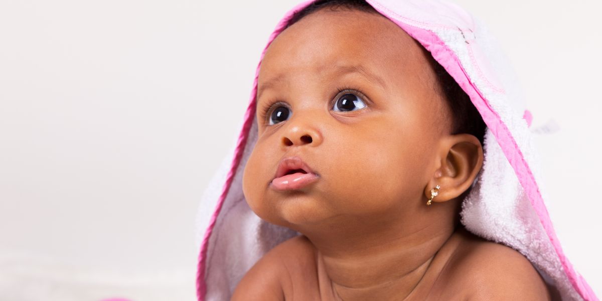 Baby with a towel on their head.