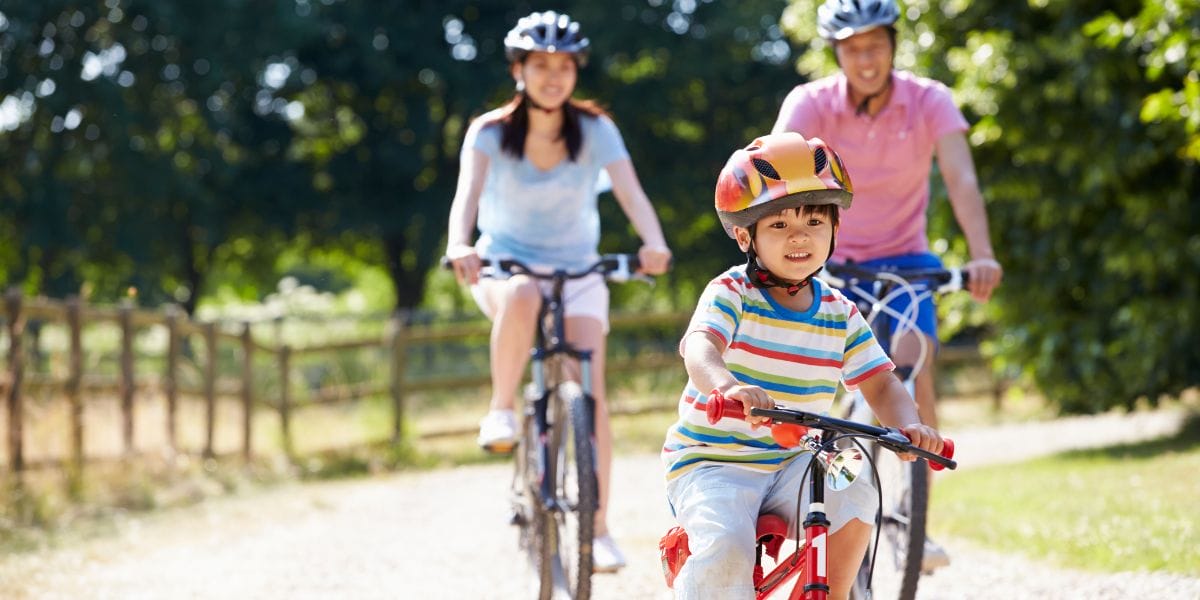 Parents and child riding their bikes