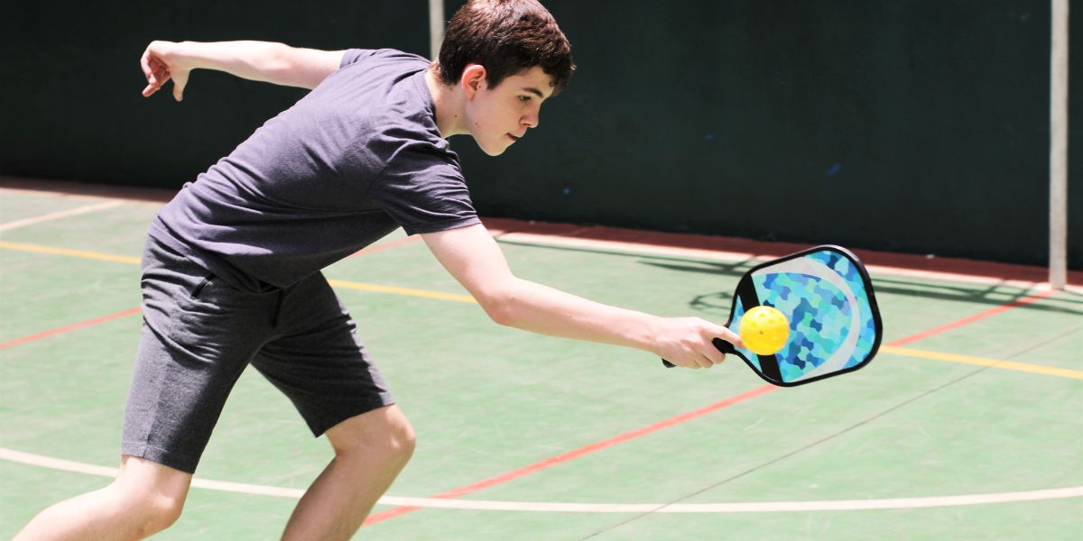 Teenager boy playing pickleball